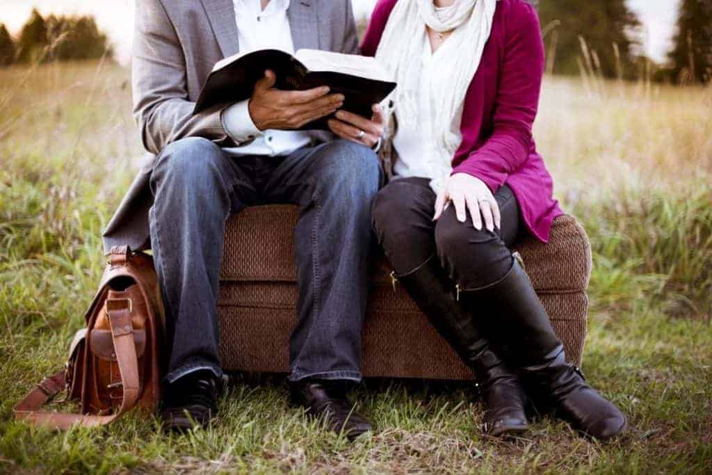 Couple reading in the grass