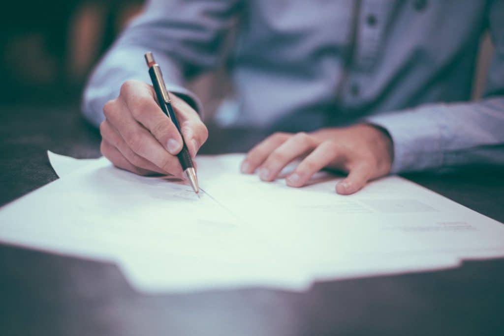 Man writing notes on paper